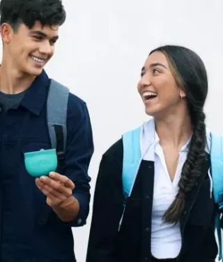 Teen couple walking with Spark Aligners