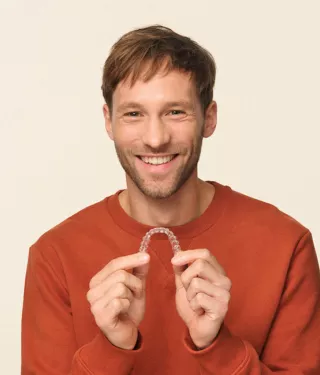 Man holding Spark Clear Aligners