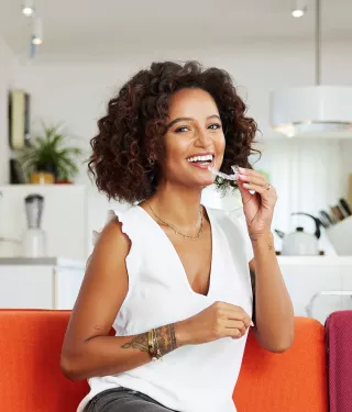 woman with spark aligners on couch