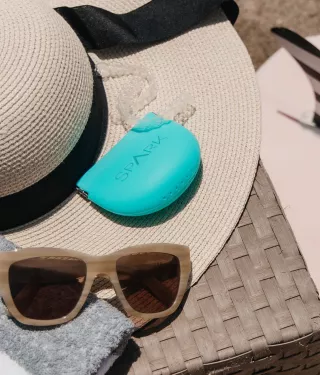 Spark Clear Aligners with a beach hat and sunglasses