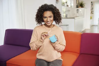 woman wearing sweater holding Spark Aligners
