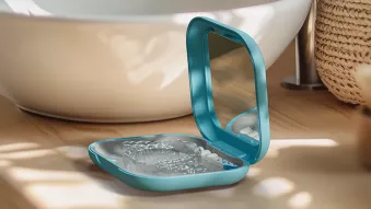 Image of a Spark Clear Aligner in its Custom Hard Case sitting on a counter top