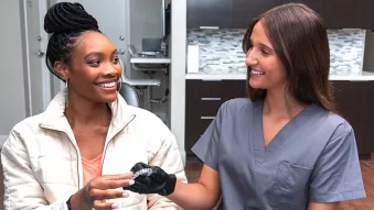 Spark Aligners doctor and smiling woman holding aligners