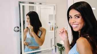 Woman holding Clear Aligners bathroom