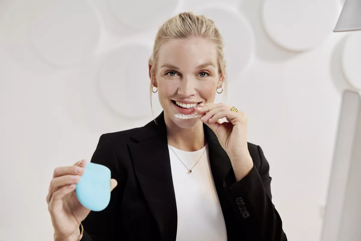 Businesswoman holding Spark Clear Aligners
