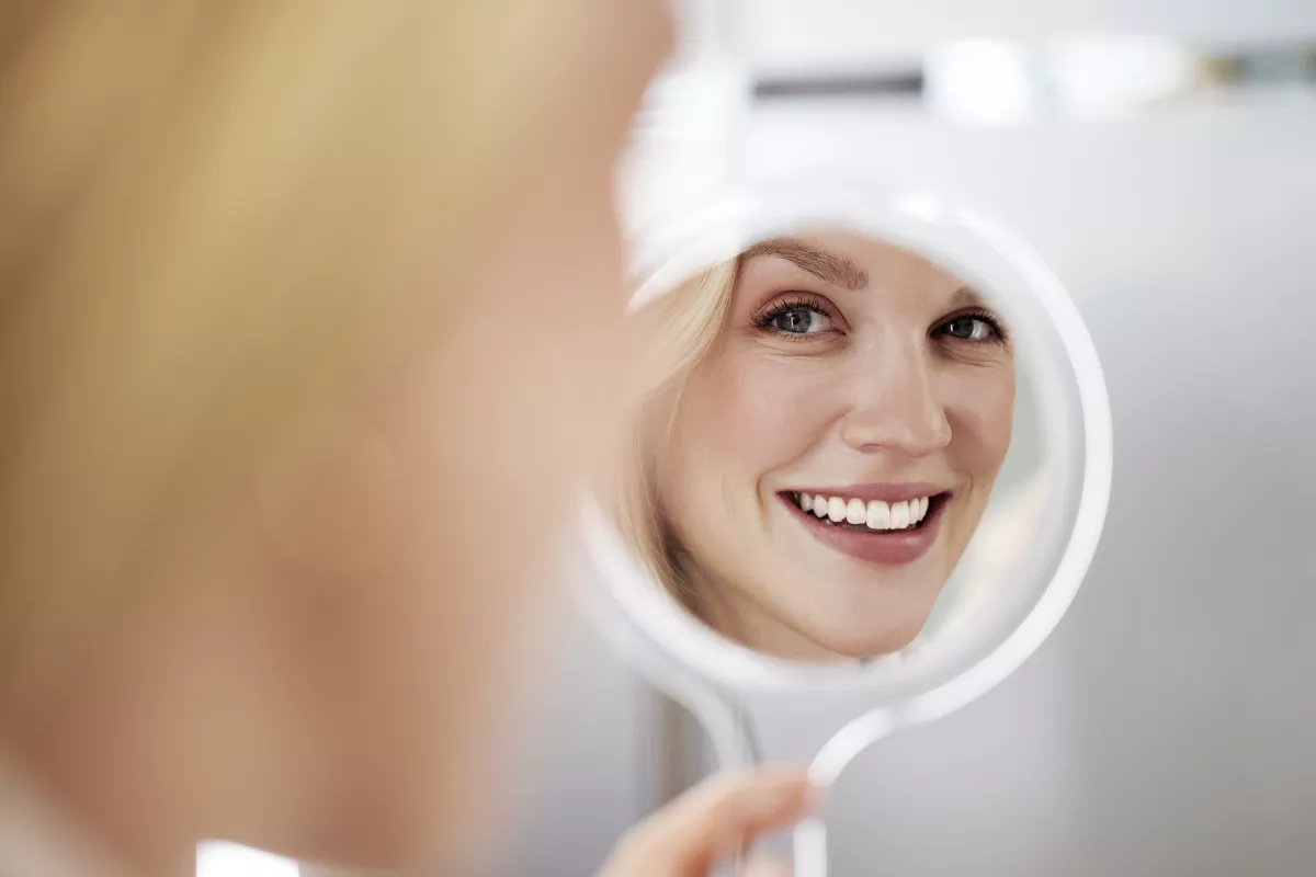Woman looking at Spark results in the mirror